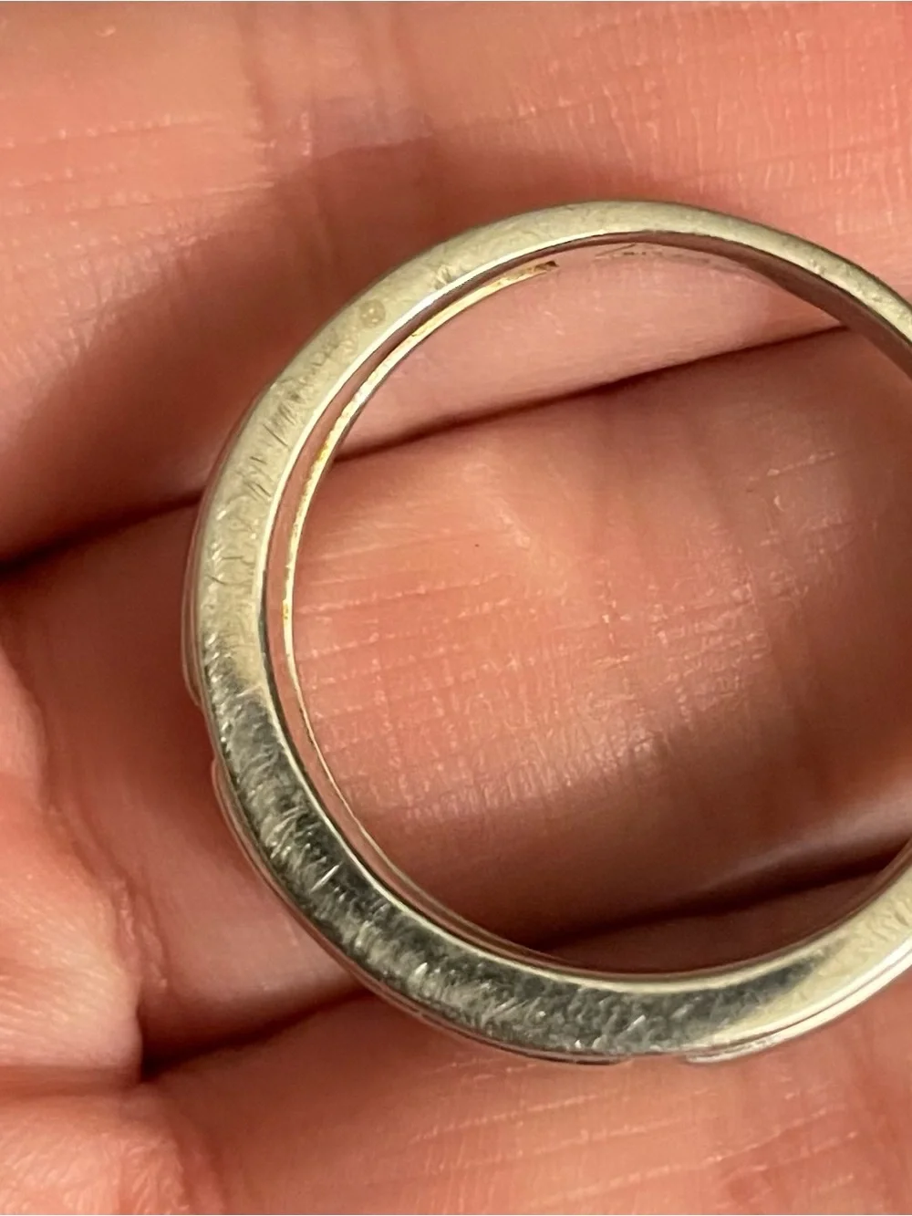 10K White Gold men’s ring. Weighing a little over 5 grams in weight.